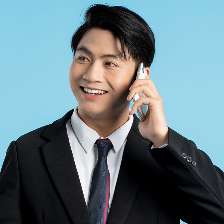 A male business professional talking on the phone